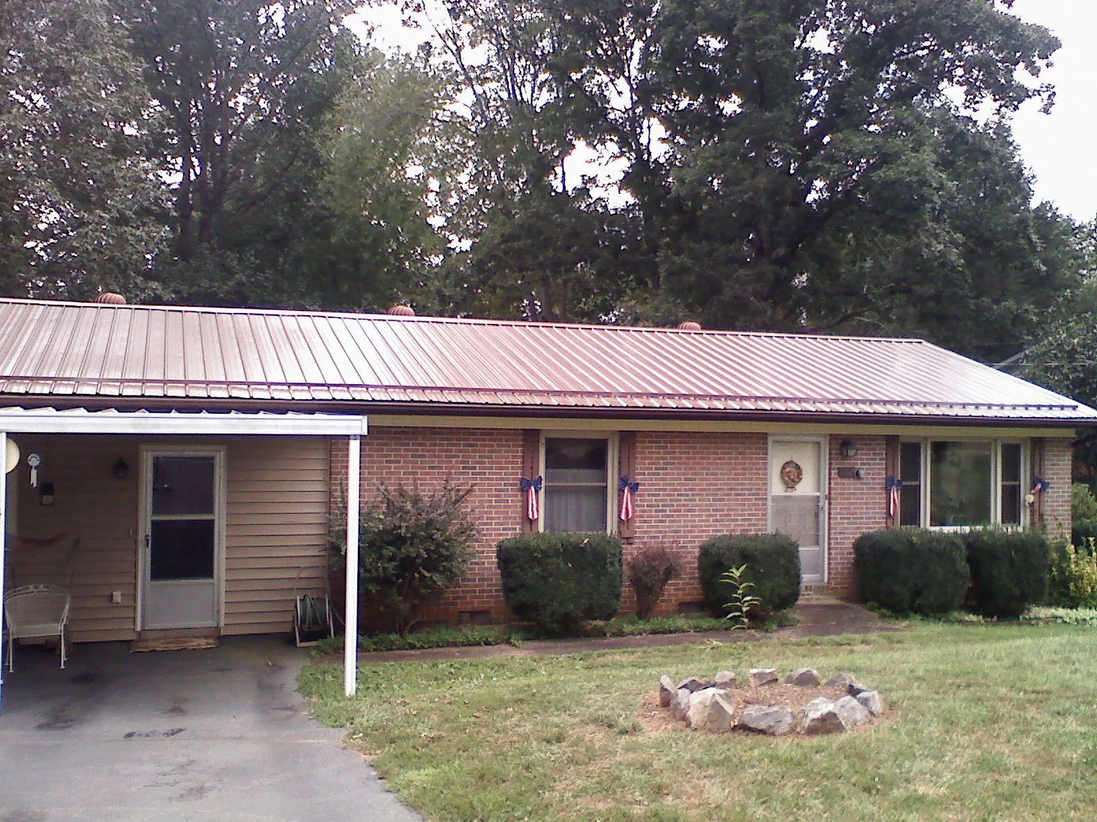 Bronze metal roof and carport on a brick ranch home — Roof Repair work by our crew in Rehoboth Beach